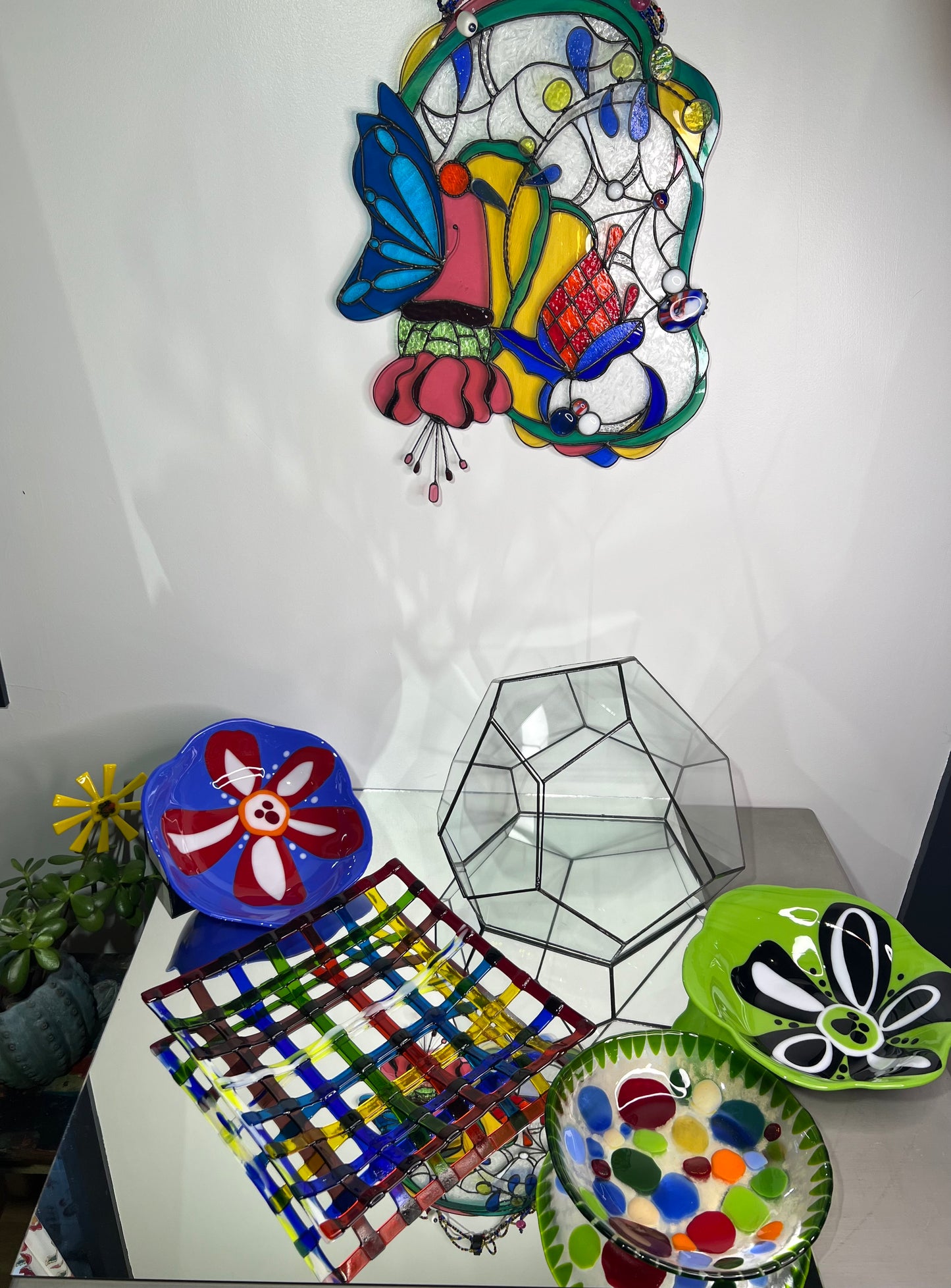 Blue glass bowl with red and white flower