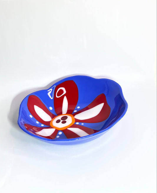 Blue glass bowl with red and white flower