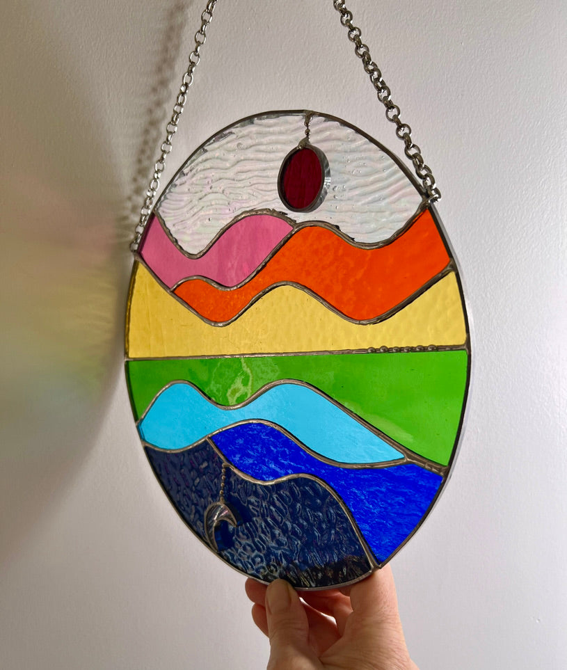 Summer Celebration, sun, moon, water, hills and sky stained glass suncatcher