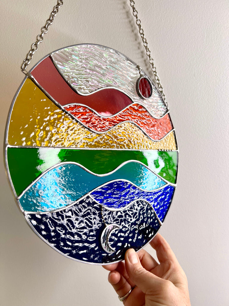 Summer Celebration, sun, moon, water, hills and sky stained glass suncatcher