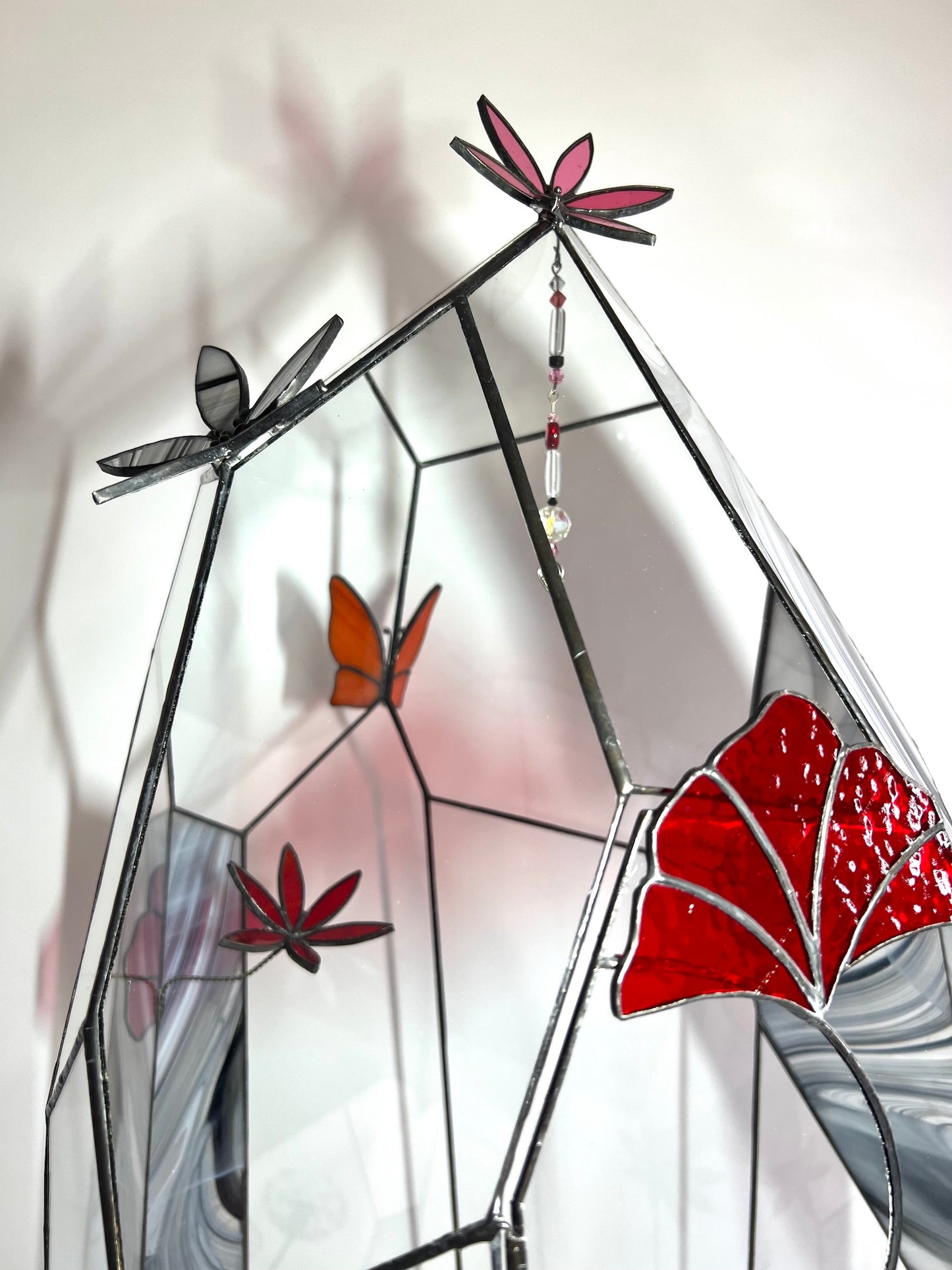 Glass terrarium, flowers, butterfly, crystals