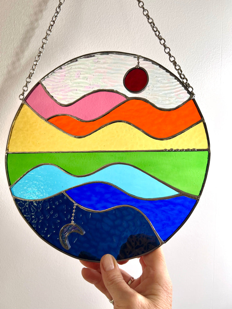 Summer Celebration, sun, moon, water, hills and sky stained glass suncatcher