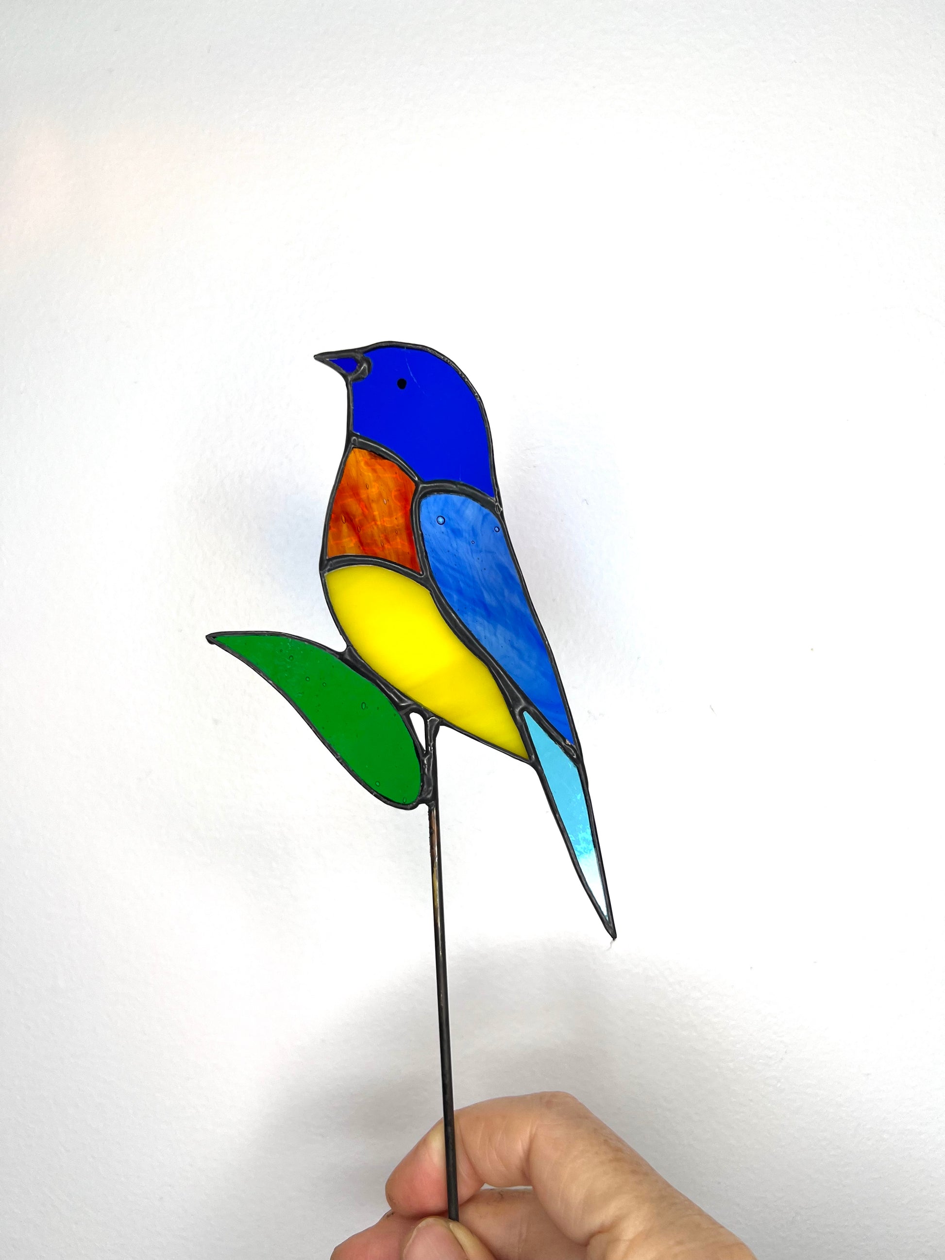 stainedglass rainbow bird and green leaf