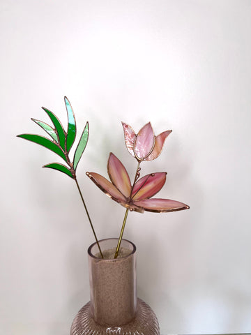 Peach and pink glass flowers with green stem
