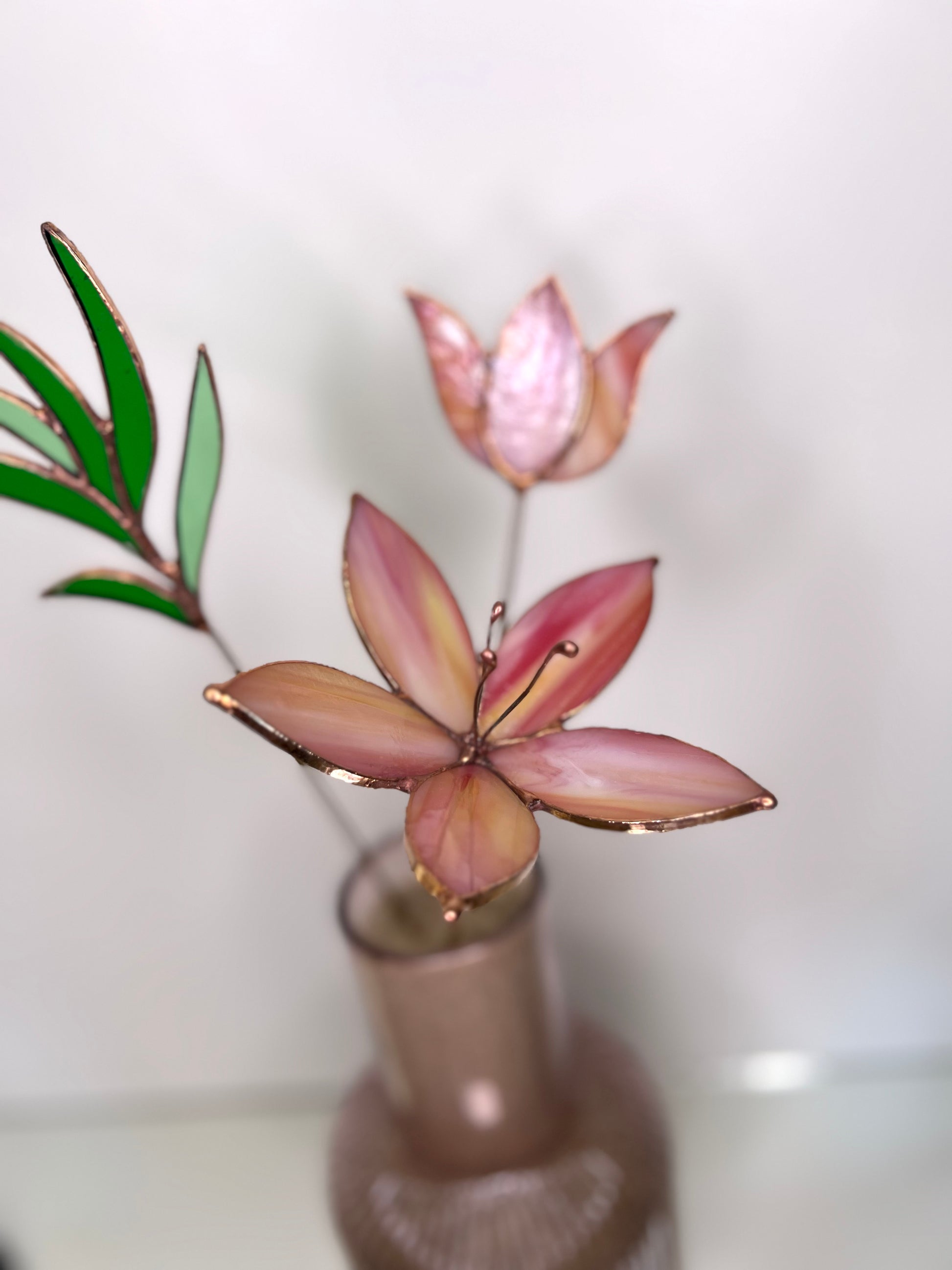 Peach and pink glass flowers with green stem