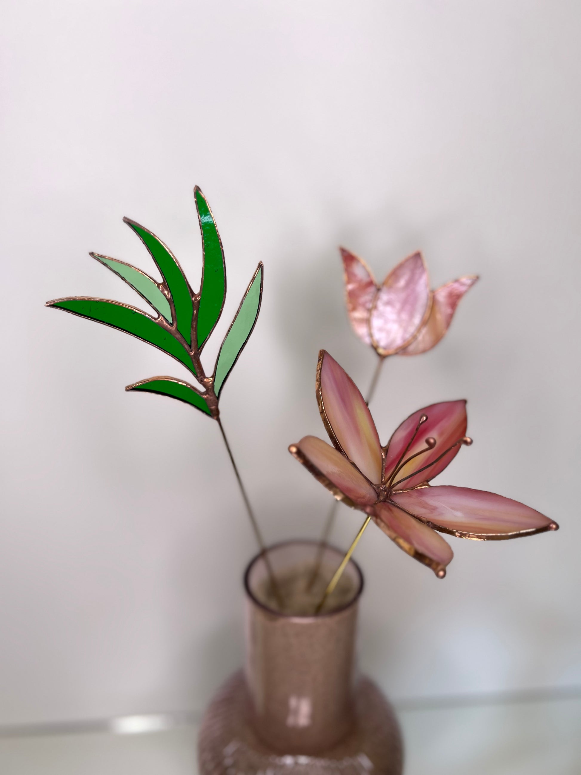 Peach and pink glass flowers with green stem