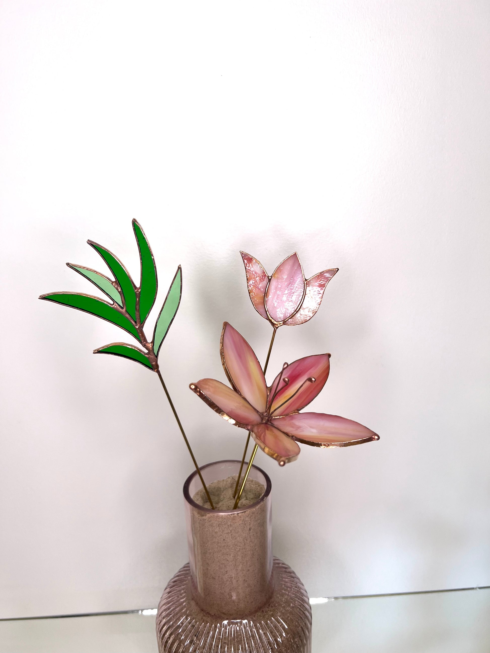 Peach and pink glass flowers with green stem