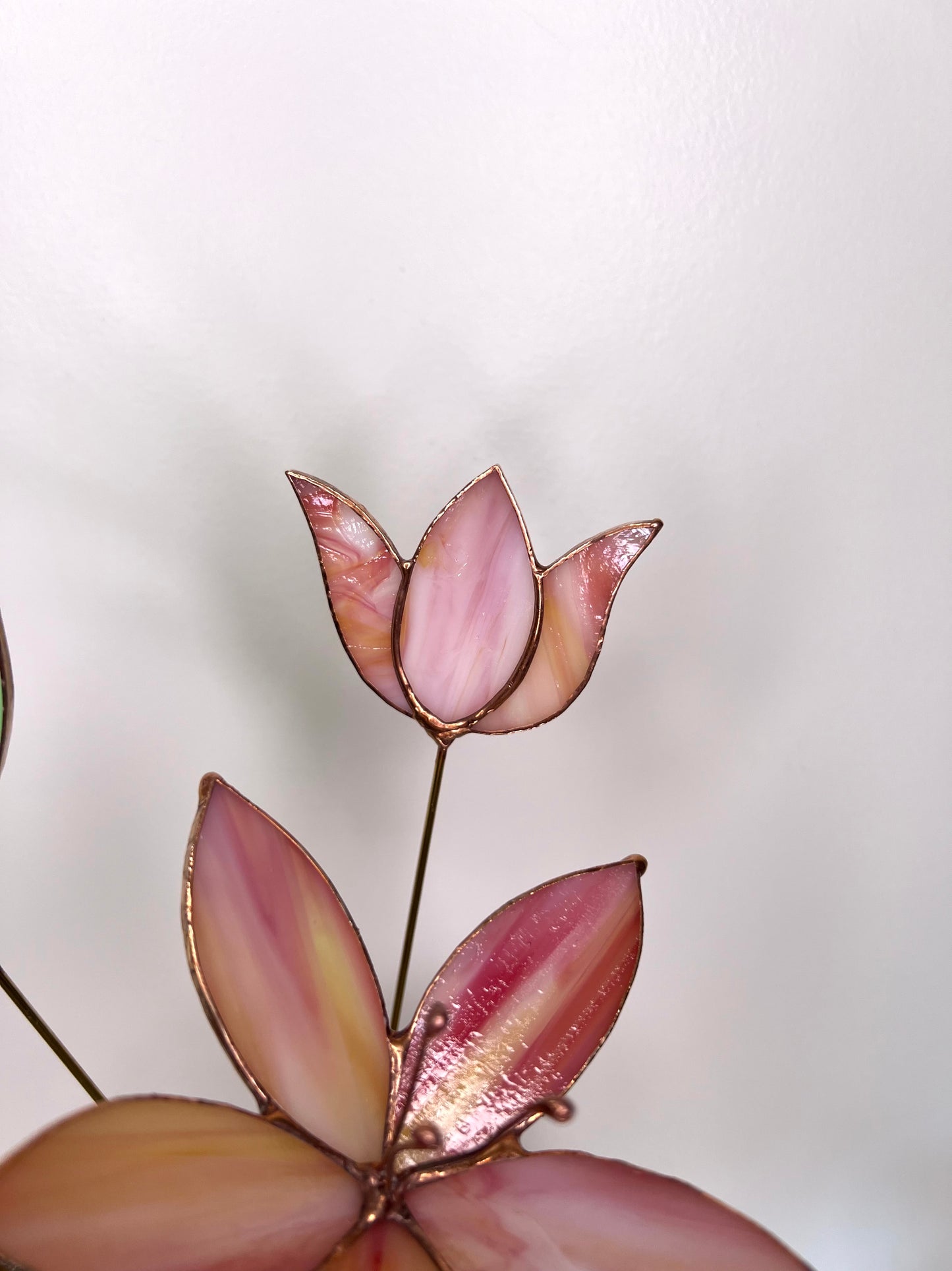 Peach and pink glass flowers with green stem