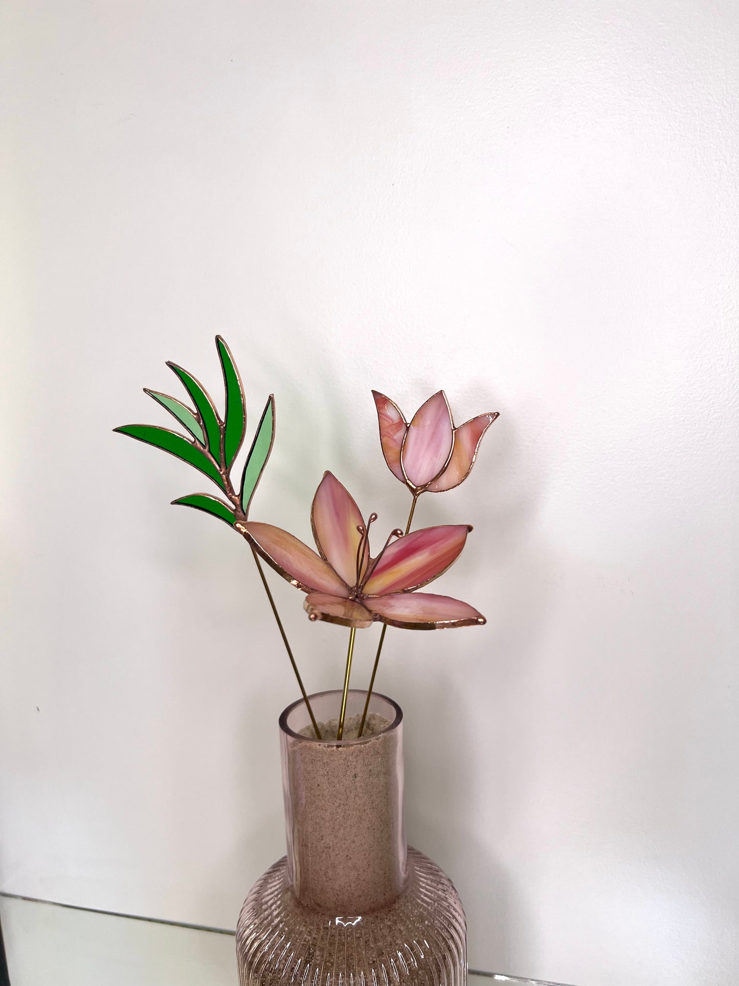 Peach and pink glass flowers with green stem