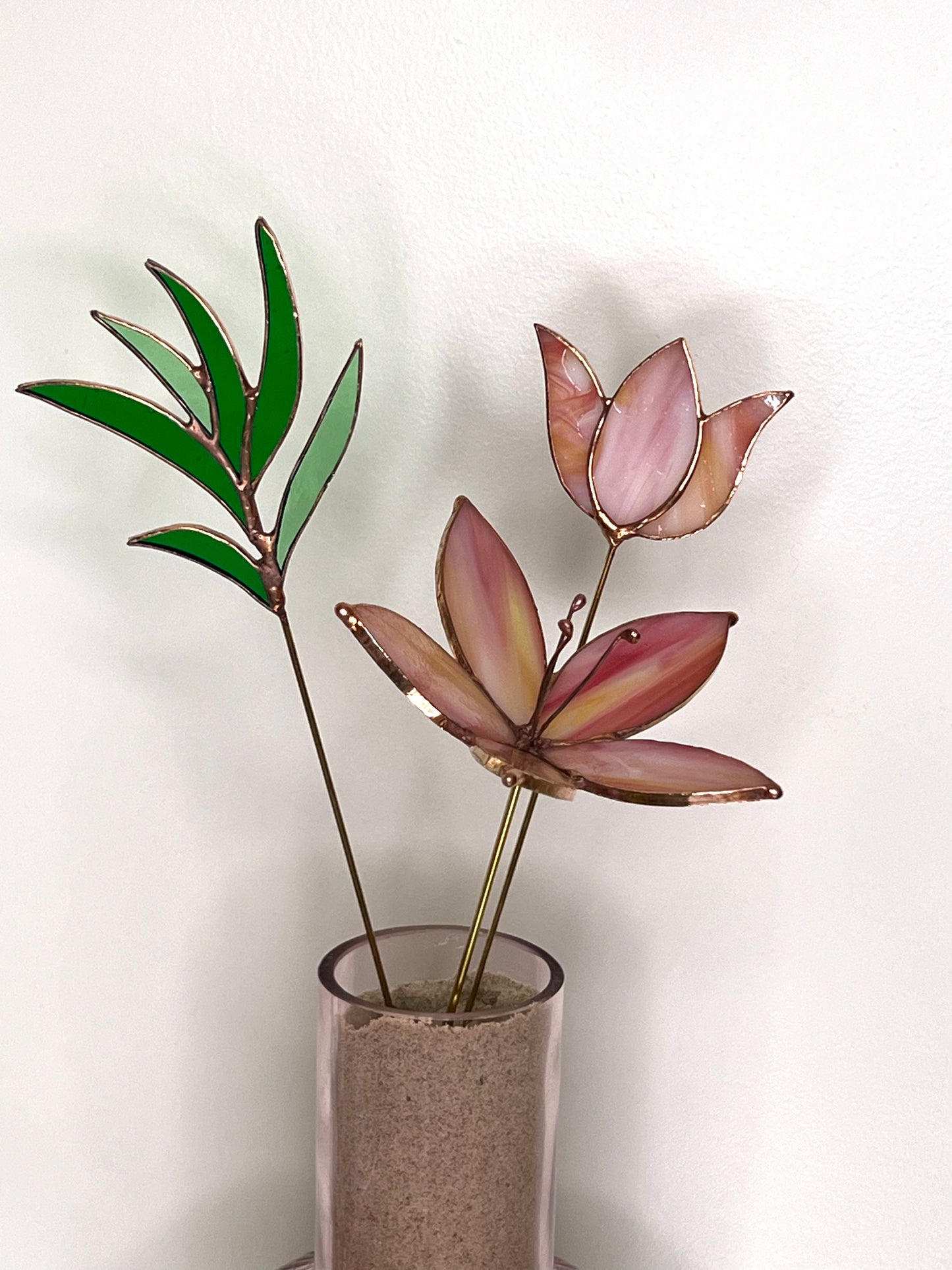 Peach and pink glass flowers with green stem