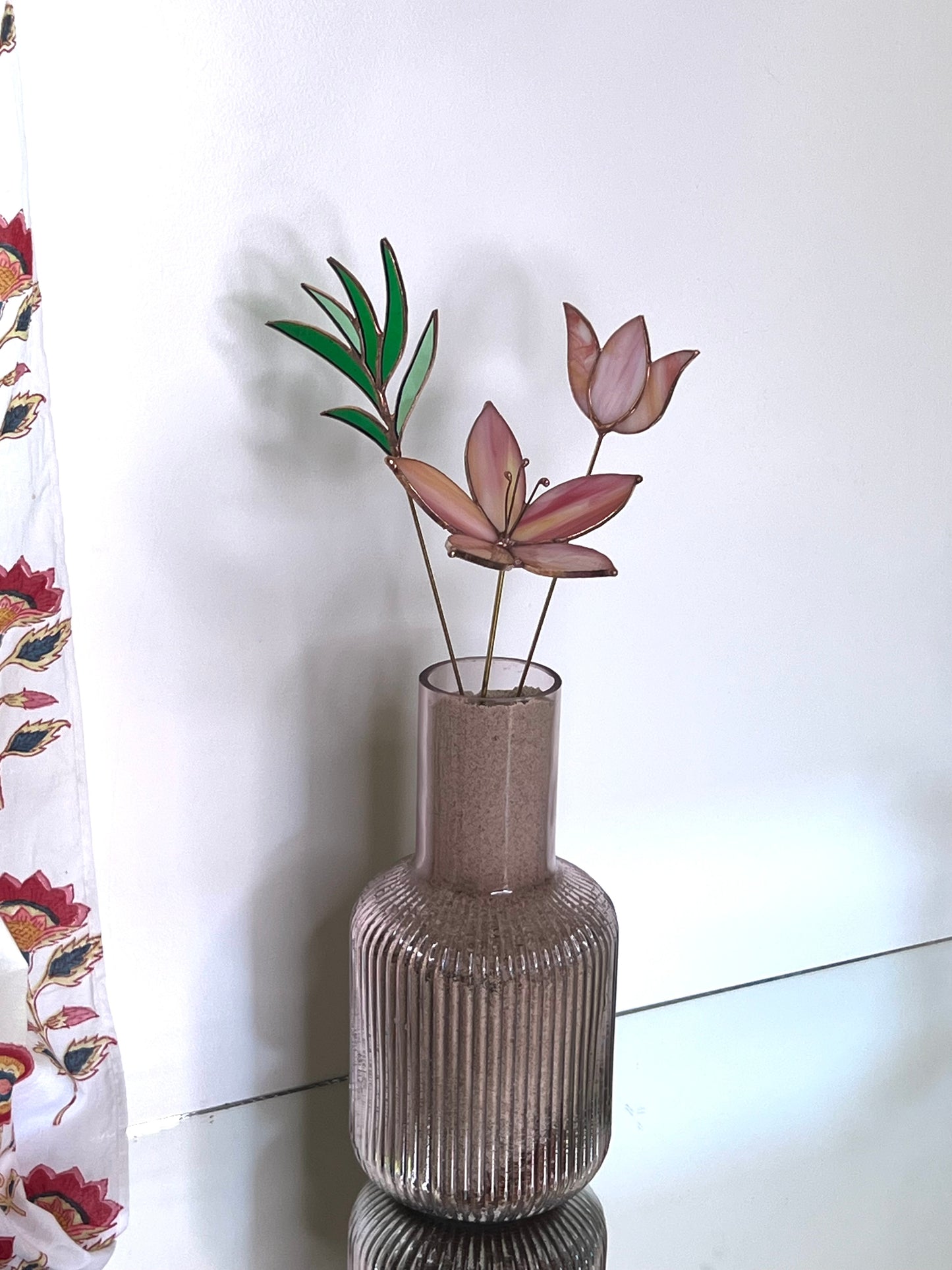 Peach and pink glass flowers with green stem