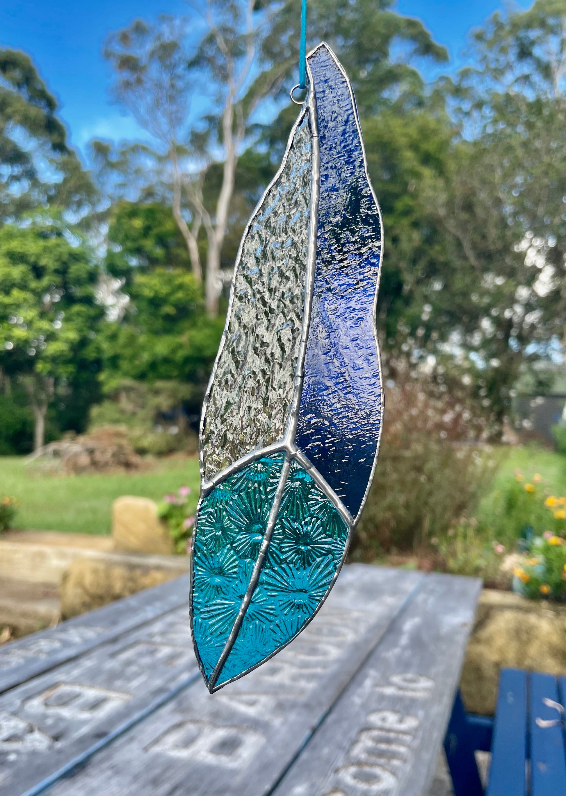 blue and texture clear glass feather