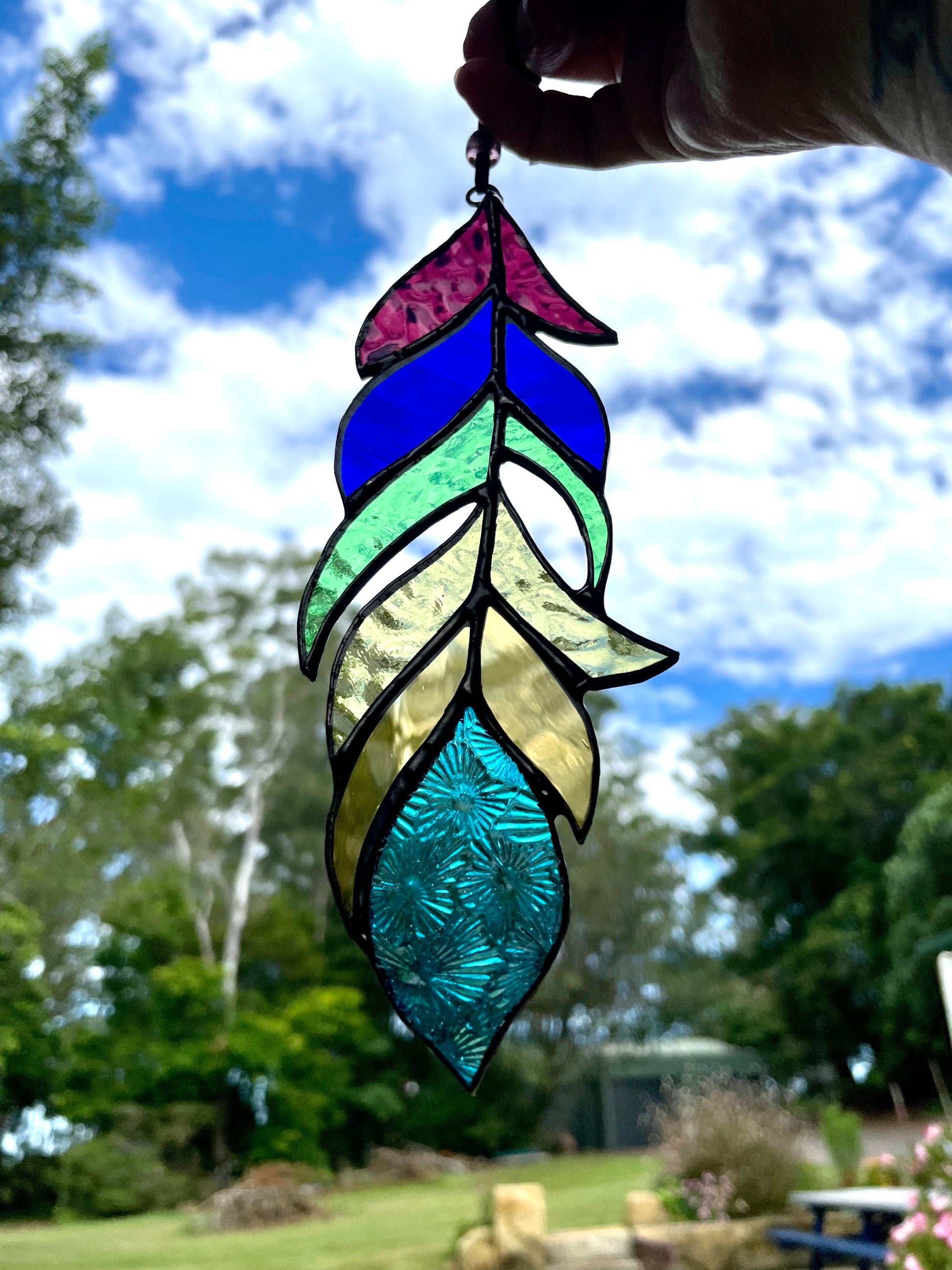 Rainbow frilly glass feather